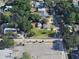Aerial shot of a property on a corner lot with an expansive lawn and mature trees at 318 Banana St, Tarpon Springs, FL 34689