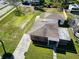 Aerial view of the property showcases a well-maintained home, yard, and garage, offering a glimpse of the neighborhood at 318 Banana St, Tarpon Springs, FL 34689