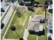 Overhead view reveals a beautifully maintained home, yard, and detached garage, showcasing the property's layout and neighborhood at 318 Banana St, Tarpon Springs, FL 34689
