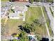 An aerial perspective of a house surrounded by a lush lawn and greenery at 318 Banana St, Tarpon Springs, FL 34689
