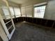 Sunroom with windows and blinds; ready for restoration and personal touches at 318 Banana St, Tarpon Springs, FL 34689