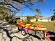 Enclosed yard with a well-maintained fence and cozy home, featuring trees and clear blue sky, creates a private outdoor space at 318 Banana St, Tarpon Springs, FL 34689