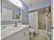 This bathroom features a white vanity, neutral tile floor, and a shower/tub combination with curtain at 319 Kelsey Way, Sun City Center, FL 33573