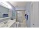 Well-lit bathroom with updated vanity, tile flooring and a shower with sliding doors at 319 Kelsey Way, Sun City Center, FL 33573