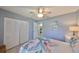 Inviting bedroom with ceiling fan, patterned bedding, and ample closet space at 319 Kelsey Way, Sun City Center, FL 33573