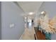 Inviting hallway with tiled flooring, leading into the main living areas with soft blue walls at 319 Kelsey Way, Sun City Center, FL 33573