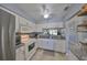 Bright kitchen featuring white cabinets, a stainless refrigerator, and a view into the dining area at 319 Kelsey Way, Sun City Center, FL 33573