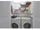 Functional laundry room featuring a washer, dryer, and shelving for extra storage at 319 Kelsey Way, Sun City Center, FL 33573