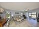 Spacious living area with tile flooring, comfortable seating, and ample natural light from the sliding glass doors at 319 Kelsey Way, Sun City Center, FL 33573