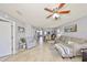 Large living room with an open layout, featuring tile flooring and a ceiling fan at 319 Kelsey Way, Sun City Center, FL 33573