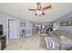 Spacious living room with open layout, tile floors, and ceiling fan at 319 Kelsey Way, Sun City Center, FL 33573