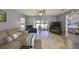 Open living room with tile floors, a ceiling fan, and sliding doors to the lanai at 319 Kelsey Way, Sun City Center, FL 33573