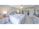Serene main bedroom with ceiling fan, closet access, and ensuite bathroom at 319 Kelsey Way, Sun City Center, FL 33573