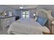 Bright main bedroom featuring a large bed, dresser with mirror, and natural lighting at 319 Kelsey Way, Sun City Center, FL 33573