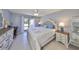 Bright main bedroom with a large window view, and white dresser and nightstand at 319 Kelsey Way, Sun City Center, FL 33573