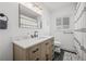 Stylish bathroom featuring a quartz vanity, modern lighting, and a shower with a patterned curtain at 3215 W Fair Oaks Ave, Tampa, FL 33611