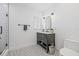 Modern bathroom features patterned tile floors, sleek black accents, and a glass shower, creating a stylish retreat at 3215 W Fair Oaks Ave, Tampa, FL 33611