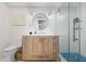Modern bathroom featuring wood vanity with marble top and a glass shower enclosure with blue mosaic floor tiles at 3215 W Fair Oaks Ave, Tampa, FL 33611