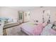 Bright bedroom featuring a cozy couch and a window with patterned curtains at 3215 W Fair Oaks Ave, Tampa, FL 33611
