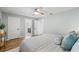 Comfortable bedroom with warm wood floors, ceiling fan, and access to the bathroom and walk in closet at 3215 W Fair Oaks Ave, Tampa, FL 33611