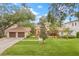 Charming single-Gathering home featuring a well-manicured lawn and an attached two-car garage at 3215 W Fair Oaks Ave, Tampa, FL 33611