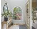 Charming foyer entrance with hardwood floors, decorative accents, and a view to lush landscaping at 3215 W Fair Oaks Ave, Tampa, FL 33611