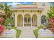 Inviting front porch featuring elegant columns, stylish seating, and views of beautiful landscaping at 3215 W Fair Oaks Ave, Tampa, FL 33611