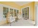 Cozy front porch with unique wicker chairs and decorative details, creating a relaxing outdoor space at 3215 W Fair Oaks Ave, Tampa, FL 33611