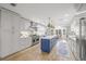 Spacious kitchen with custom cabinetry, stainless steel appliances, large island, and stylish pendant lighting at 3215 W Fair Oaks Ave, Tampa, FL 33611