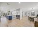 Open-concept kitchen and dining area with stainless steel appliances and a large kitchen island at 3215 W Fair Oaks Ave, Tampa, FL 33611