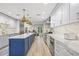 Bright kitchen with a central island, stainless steel appliances, and a modern design, great for entertaining at 3215 W Fair Oaks Ave, Tampa, FL 33611