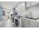 Modern laundry room with stylish patterned tile floor and ample cabinet space at 3215 W Fair Oaks Ave, Tampa, FL 33611