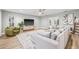 Bright living room with hardwood floors, ceiling fan, and comfortable seating arrangement at 3215 W Fair Oaks Ave, Tampa, FL 33611