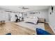 Serene bedroom featuring hardwood floors, barn doors, ceiling fan, and exercise equipment at 3215 W Fair Oaks Ave, Tampa, FL 33611