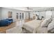 Bright main bedroom features hardwood floors, barn doors, ceiling fan, and access to pool at 3215 W Fair Oaks Ave, Tampa, FL 33611