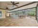 Covered patio with outdoor dining and seating areas within a screened enclosure at 3215 W Fair Oaks Ave, Tampa, FL 33611