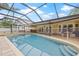 Enclosed pool with stone hot tub and screened enclosure at 3215 W Fair Oaks Ave, Tampa, FL 33611