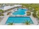 Stunning aerial view of the resort-style pool area with ample lounge chairs, landscaping, and recreation at 3504 Golden Wheat Ln, Plant City, FL 33565
