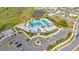 Aerial view of community clubhouse with pool, parking and surrounding neighborhoods and landscaping at 3504 Golden Wheat Ln, Plant City, FL 33565