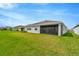 Spacious backyard featuring a screened-in lanai and lush green lawn, ideal for outdoor activities at 3504 Golden Wheat Ln, Plant City, FL 33565