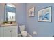 Charming powder room features a blue color scheme, floral art, and granite vanity top at 3504 Golden Wheat Ln, Plant City, FL 33565