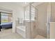 Bathroom featuring a tiled shower, tub, and an open view to the main bedroom at 3504 Golden Wheat Ln, Plant City, FL 33565