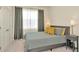Well-lit bedroom with neutral tones, decorative pillows, and blackout curtains for relaxation at 3504 Golden Wheat Ln, Plant City, FL 33565