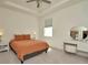 Comfortable bedroom featuring a queen size bed, bedside tables, and a vanity with a round mirror at 3504 Golden Wheat Ln, Plant City, FL 33565
