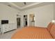 Spacious bedroom with access to ensuite bathroom and walk-in closet, and kitchen area at 3504 Golden Wheat Ln, Plant City, FL 33565