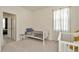 Bright bedroom with white trim, single bed, and sheer curtains filtering natural light at 3504 Golden Wheat Ln, Plant City, FL 33565