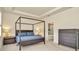 Spacious primary bedroom featuring a four-poster bed, recessed lighting, and access to an ensuite bathroom at 3504 Golden Wheat Ln, Plant City, FL 33565