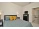 Comfortable bedroom featuring plush bedding, a modern dresser, and views into an adjacent room at 3504 Golden Wheat Ln, Plant City, FL 33565