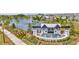 Scenic view of the 'Farm at Varrea' entrance with lush landscaping, a pond, and cascading fountains at 3504 Golden Wheat Ln, Plant City, FL 33565