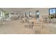 Spacious dining area with neutral-toned tables and chairs, perfect for gatherings and events at 3504 Golden Wheat Ln, Plant City, FL 33565